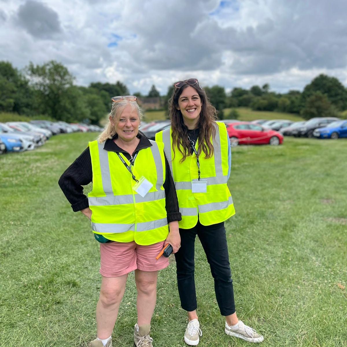 Two volunteers smiling.
