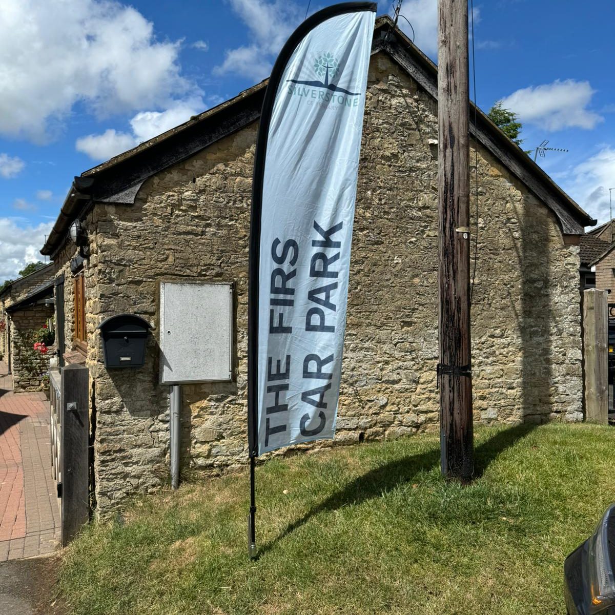 Flag with "The Firs Car Park" written on it.
