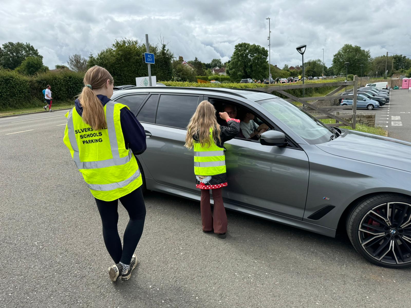 Child volunteer scanning customer's ticket.