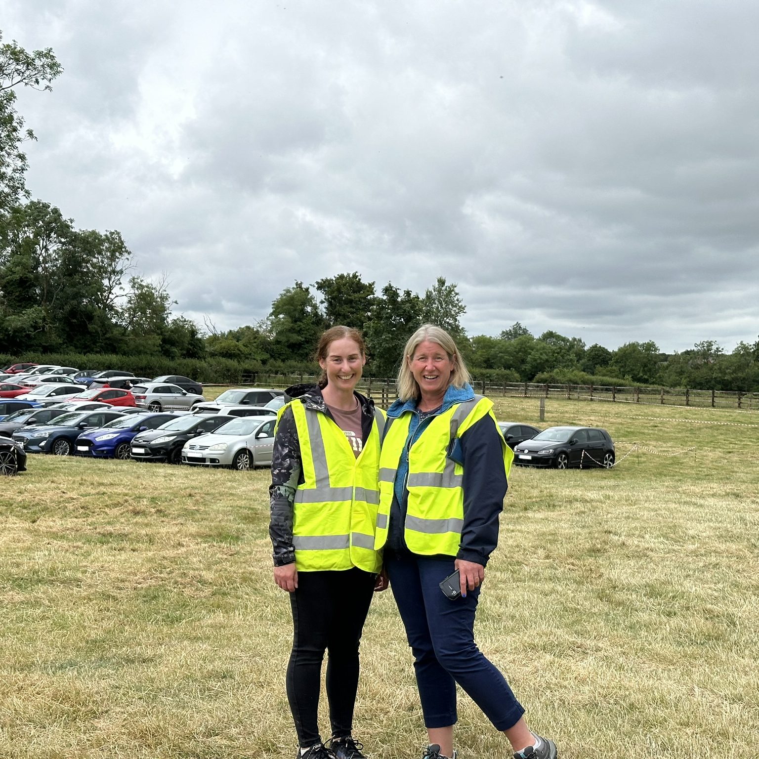 Two volunteers smiling.