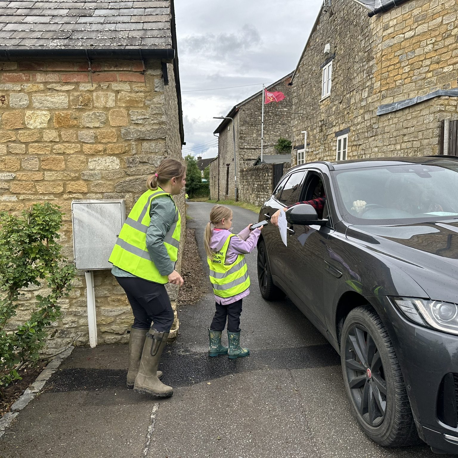 Child volunteer scanning customer's ticket.