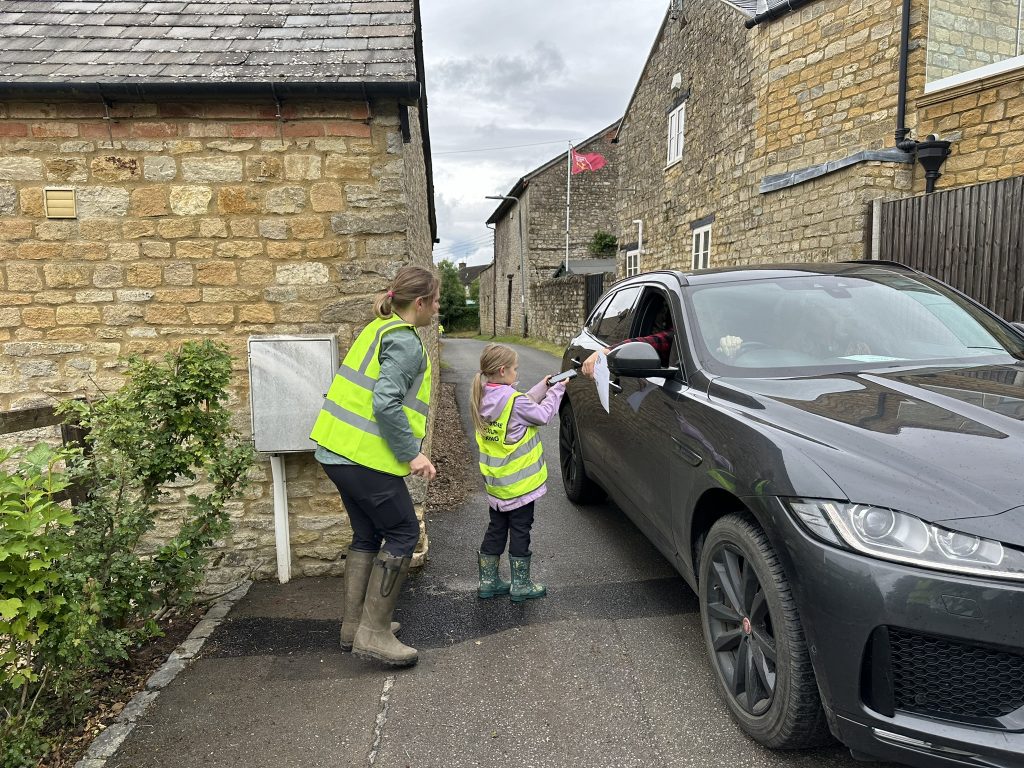 Child volunteer scanning customer's ticket.