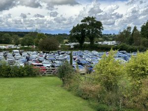 Cars parked in field.